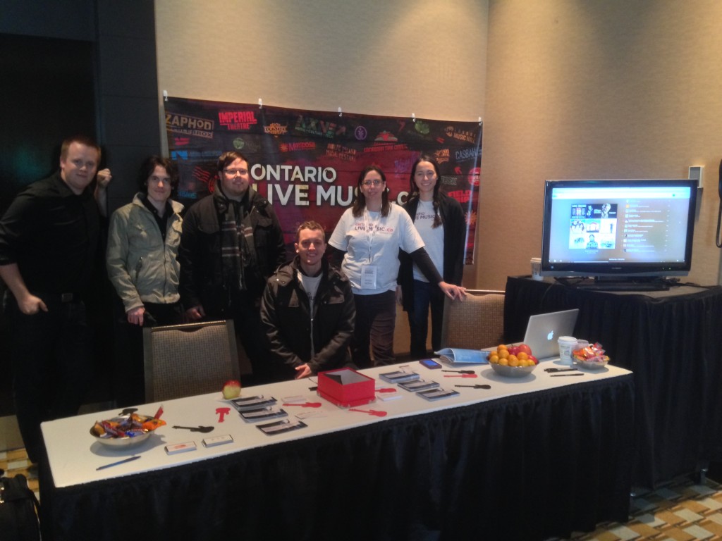 Hamilton’s DB Cooper, OntarioLiveMusic.ca Project Manager Amber Authier and Data Manager Sarah Rix pose at the OntarioLiveMusic.ca booth at the Ontario Tourism Summit in Blue Mountains, ON.
